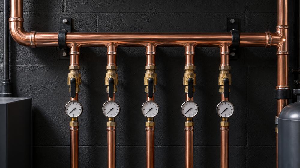 Copper and steel piping header with valves and gauges
